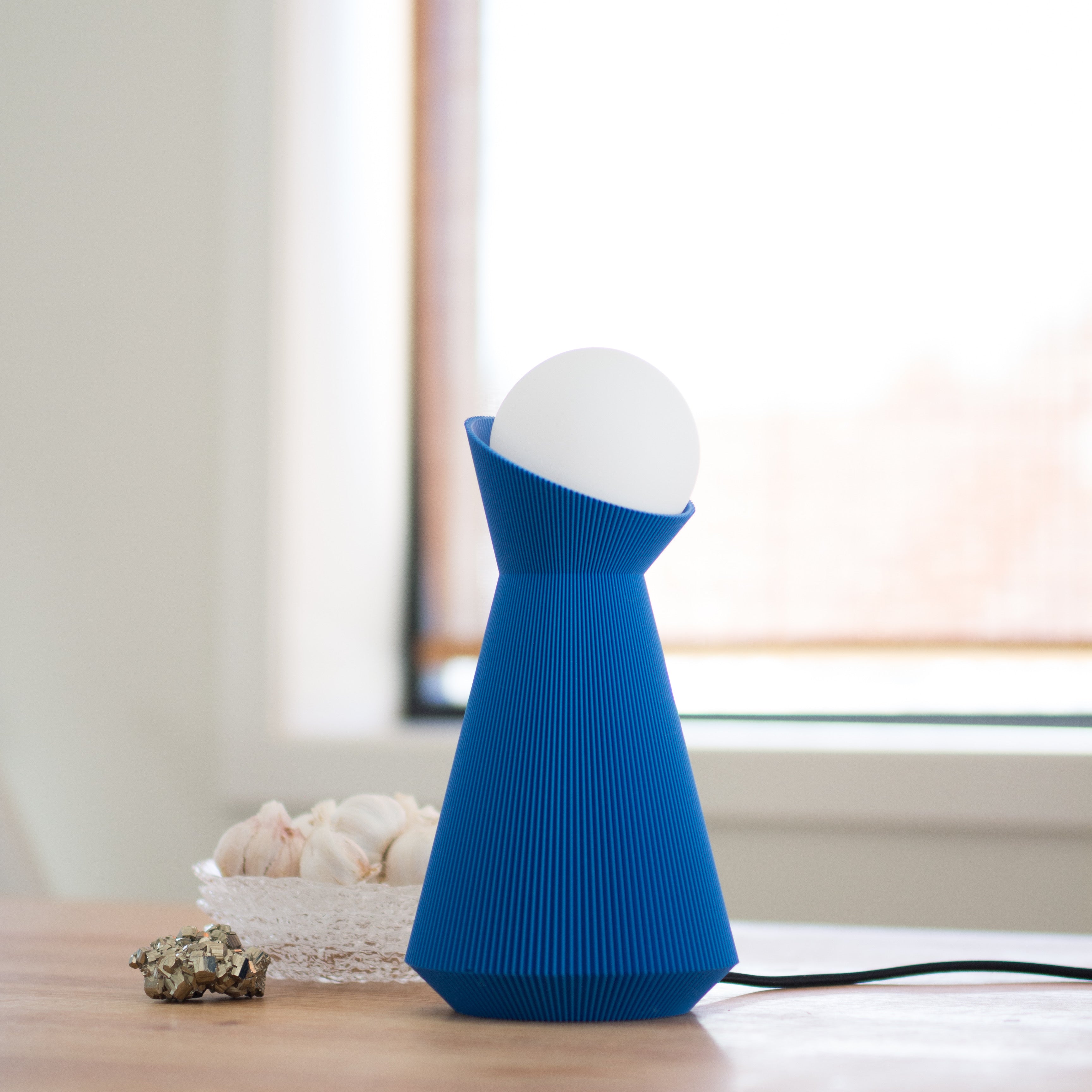 Blue and white lamp on a table with a blurred background