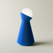 Blue and white geometric lamp on a light gray background