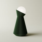 Forrest green sera table lamp with white dekorative light bulb on a light gray background