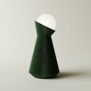 Forest green Sera table lamp with a white decorative bulb on a light grey background